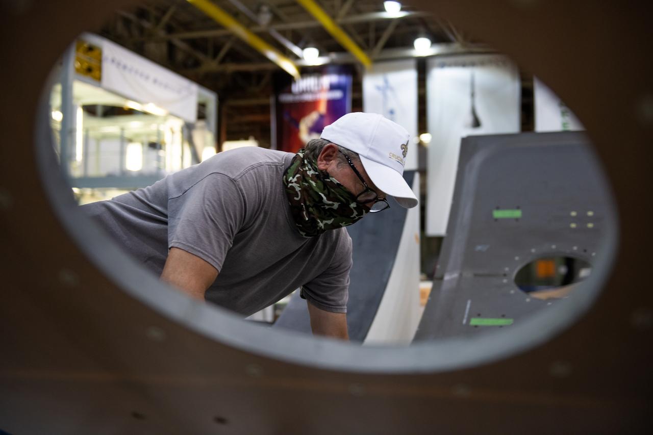 Employees wear personal protective gear at  Michoud Assembly Facility as the facility transitioned to Stage 3 of NASA’s Framework for Return To On-Site Work. Employees wear the appropriate personal protective equipment (PPE) and/or cloth face coverings as required for assigned tasks. Access to the facility is limited to authorized personnel working on mission-critical tasks that must be conducted onsite. Mission-critical tasks include slowly and methodically resuming Space Launch System (SLS) Core Stage and Orion production activities, particularly critical path deliverables to support the Artemis Program, at a pace that limits personnel and follows federal guidelines for social distancing and use of personal protective equipment such as face masks. For more information about SLS, visit nasa.gov/sls.